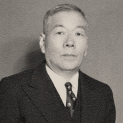 Jukichi Harada in a dark suit and tie.