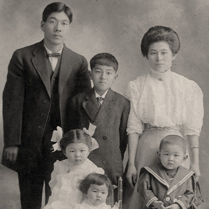 Family portrait, circa 1910, of Jukichi, Ken, Masa Atsu, Mine, Tadao, and Sumi Harada. Tadao Harada is dressed in a sailor suit.